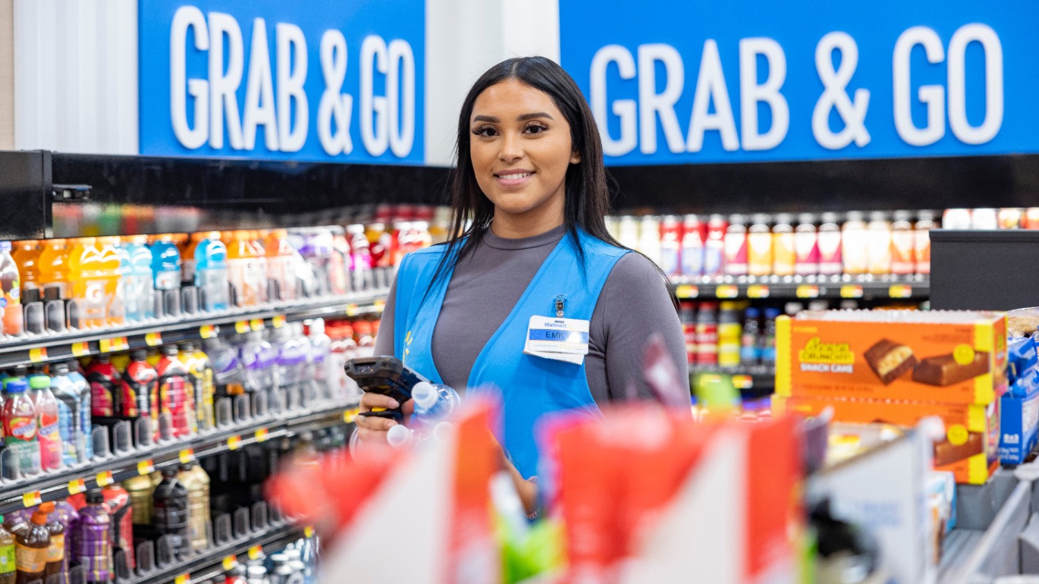 Walmart Associate Scanning Product in Grocery Aisle